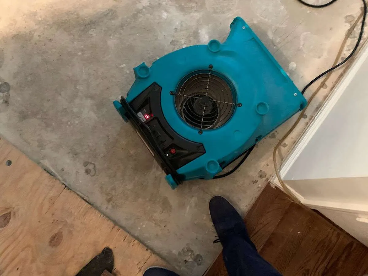 Air mover drying subfloor during Commercial Water Damage Restoration in Grenada